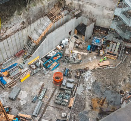 Storage area of a construction site with lots of different equipment and material, seen from above. Stockholm Sweden